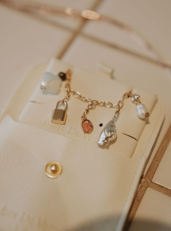 Gold Charm Bracelet with Pearls & Gemstones | Mare De Vetro Gold charm bracelet featuring mixed charms, including pearl, gemstone and Murano-style charms, handmade by Mare De Vetro in Brisbane.